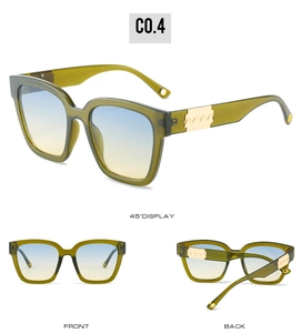 Detail view of dark green square sunglasses with gradient lenses and gold wave temple accents