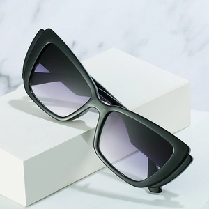 Trendy cat eye sunglasses with black frame and purple gradient lenses on a marble background