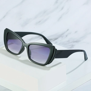 Modern black cat-eye sunglasses with purple gradient lenses on marble background