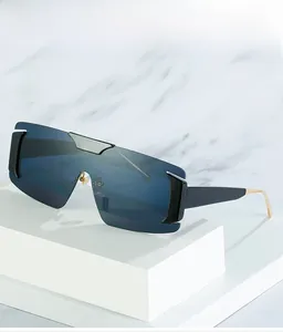Detail of oversized shield sunglasses with deep blue mirror lenses and wide black frames