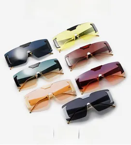Flat lay of oversized rimless sunglasses in multiple vibrant gradient color variations