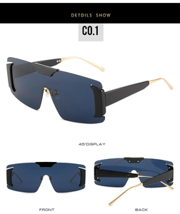 Detail view of oversized shield sunglasses with deep blue UV lenses and golden temples