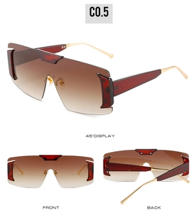 Detailed views of oversized gradient sunglasses with brown lenses and golden metal temples