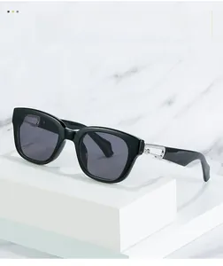 Close-up of black square sunglasses featuring a silver hollow metal buckle on the temple