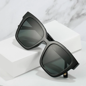 Modern square oversized black sunglasses on marble background with high-quality frame