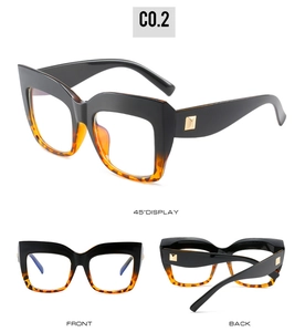 Cat eye glasses with black and tortoiseshell frame, gold rivets and clear lenses