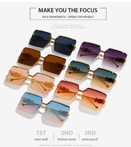 Flat lay of colorful oversized rimless sunglasses featuring gradient lenses and metal temples