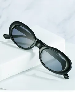 Detailed macro view of black oval sunglasses frames with durable metal hinge construction