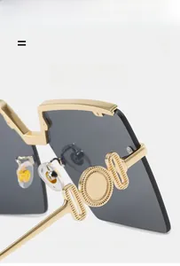 Detail of gold metal sunglasses frame with unique circular hinge design and grey lenses