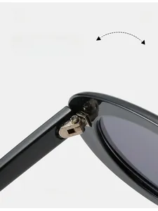 Macro shot of durable metal hinge on black retro oval sunglasses frame