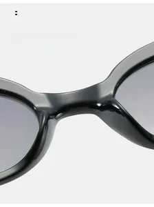 Macro view of the comfortable nose pads on these trendy black oval vintage sunglasses