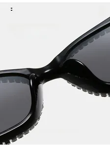 Detail of comfortable integrated nose pads and rhinestone embellishments on black sunglasses