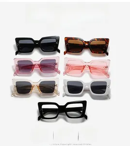 Flat lay of cat eye sunglasses in multiple colors with golden rivet hinge details