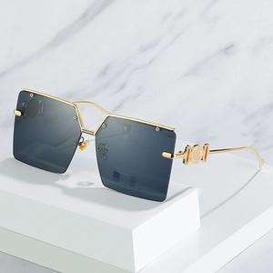 Fashionable oversized square sunglasses with gold metal frames and openwork temple details