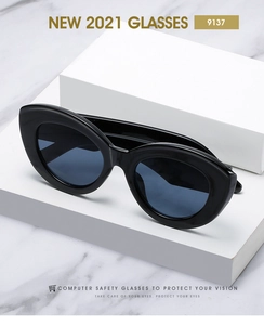 Detail view of black cat-eye computer glasses on white marble background, model 9137