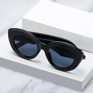 Chic oversized cat eye sunglasses with thick black frames and dark blue lenses on display