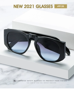 Detail of retro oversized sunglasses with blue-purple gradient lenses on marble texture