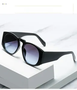Detail of oversized round sunglasses with purple to light blue gradient lenses