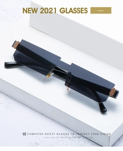 Close-up of narrow rimless sunglasses featuring geometric top edge and gold metal accents