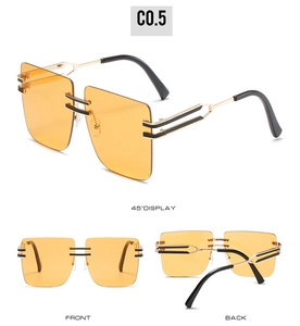 Detailed views of oversized square rimless sunglasses with yellow lenses and double bars