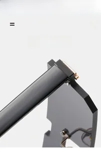 Detail of matte black sunglasses frame with gold hinges, lightweight and elastic material
