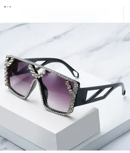 Detailed shot of rectangle sunglasses with hand-set rhinestones and purple gradient lenses