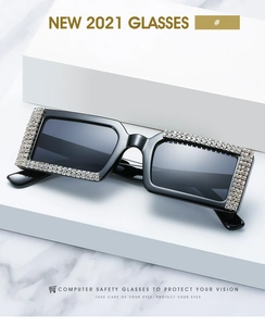 Macro detail of luxury square sunglasses with shimmering rhinestones on black frames