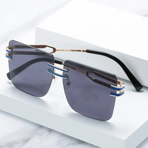 Oversized square rimless sunglasses with gold metal frame and blue enamel bridge detail