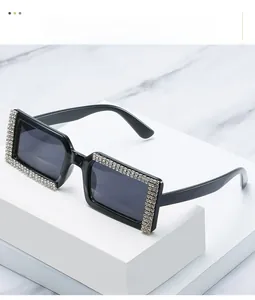 Detailed view of oversized square sunglasses featuring multiple rows of encrusted rhinestones