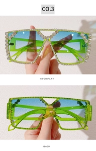Macro view showing neon green crystal frame and back structure of oversized party sunglasses