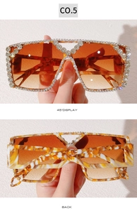 Detail view of oversized rhinestone sunglasses with gradient lenses and tortoise temples
