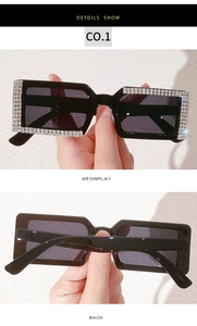 Detail of black oversized sunglasses with double-row sparkling rhinestones on the frame