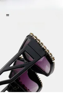 Close-up of oversized sunglasses with champagne rhinestones and purple gradient lenses