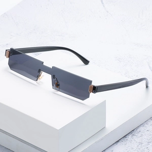 Modern rimless rectangular sunglasses with gold metallic accents on white platform