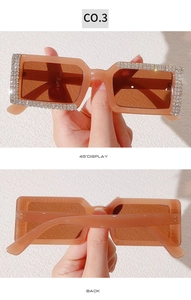 Detail of coral pink rectangle sunglasses with double-row rhinestones and dark tea lenses