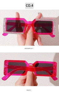 Close-up of rose red rhinestone rectangular sunglasses with sparkling crystal frame