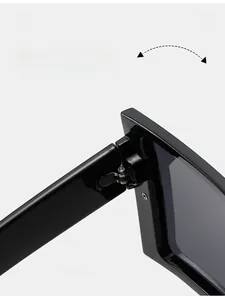 Detail of durable metal hinge on black oversized square frame sunglasses