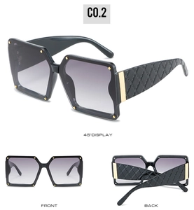 Detailed views of black oversized square sunglasses with gold rivets and quilted temples