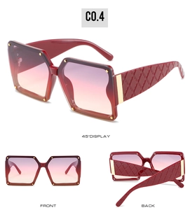 Detail view of burgundy square sunglasses with quilted texture temples and golden accents