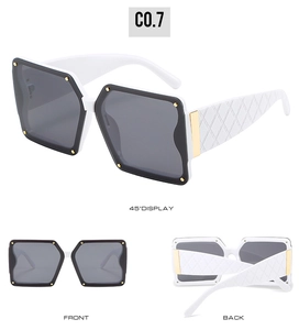 Detail view of white square sunglasses with gold rivets and quilted texture on temples