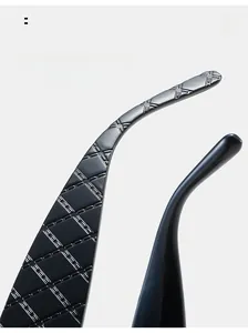 Detail of curved black sunglasses arms featuring textured quilted pattern and stitching