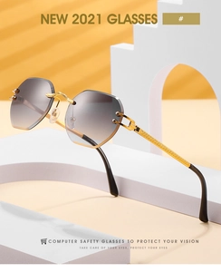 Macro shot of rimless gradient lenses and gold metal temples with detailed texture
