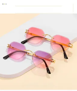 Close-up of frameless octagonal rimless sunglasses with gold textured metal temples