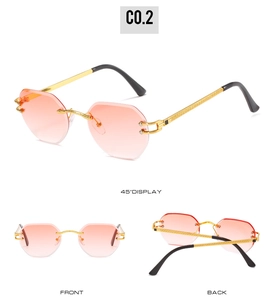 Detail view of rimless gradient lenses and gold textured metal temples on fashion sunglasses
