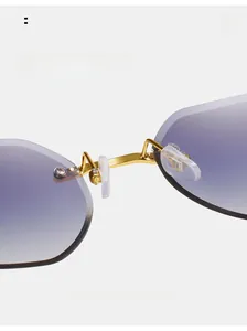 Detail of comfortable silicone nose pads and golden metal bridge on rimless sunglasses