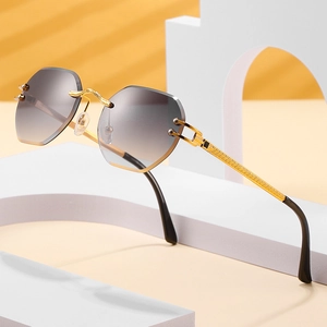 Frameless rimless sunglasses with gradient grey lenses and golden textured metal temples