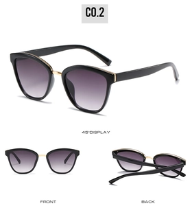 Detail view of oversized retro sunglasses with black frames and gradient purple lenses