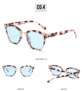 Detail view of tortoiseshell frame sunglasses with blue lenses and gold metal bridge