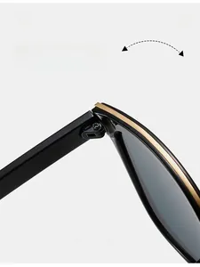 Macro shot of durable golden metal hinge detail on premium black vintage sunglasses