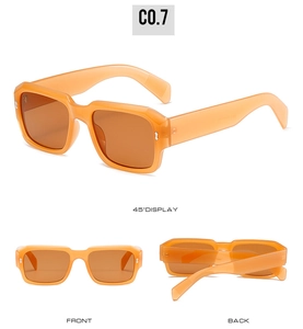 Three-angle display of retro square amber orange sunglasses with silver rivet details